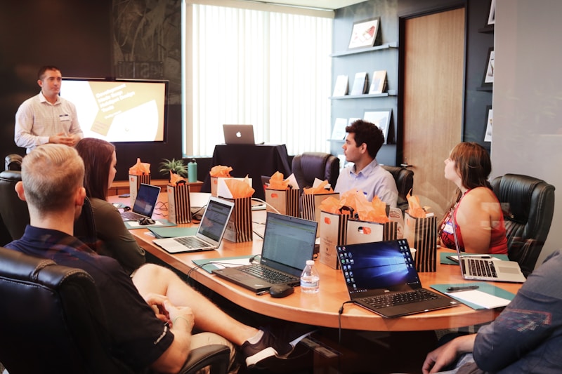 A consultant presenting to a team at computers