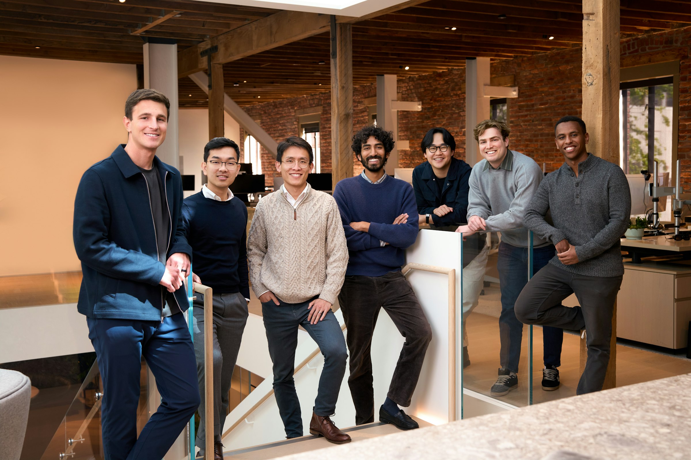 A diverse team standing together in a modern office